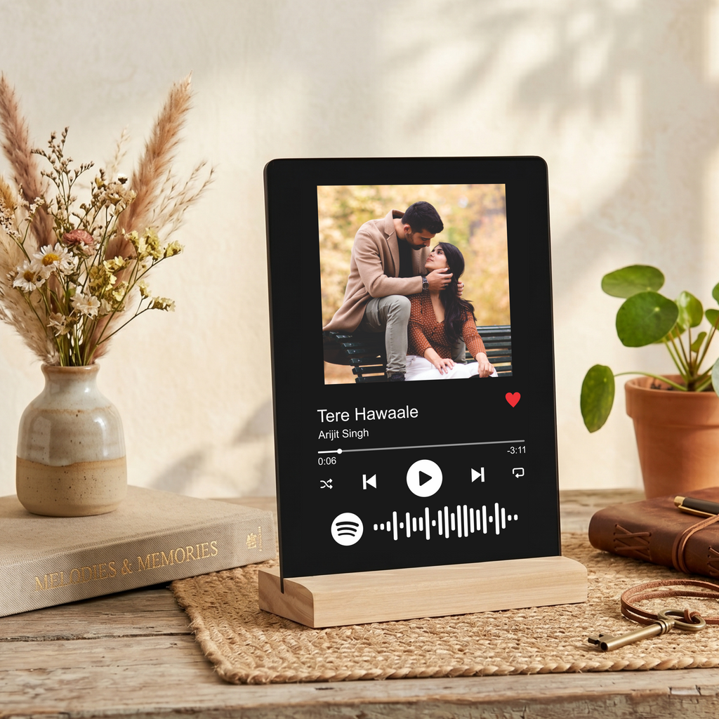 Black acrylic photo frame on wooden stand with couple photo and music waveform icons