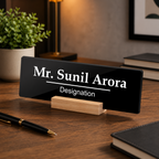 Black acrylic desk name plate showing Mr. Sunil Arora, Designation, on wooden stand