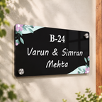 Black acrylic door name plate with floral corners, B-24 and Varun & Simran Mehta.