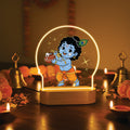 LED night lamp with glowing arch and dancing baby Krishna figure, warm light base