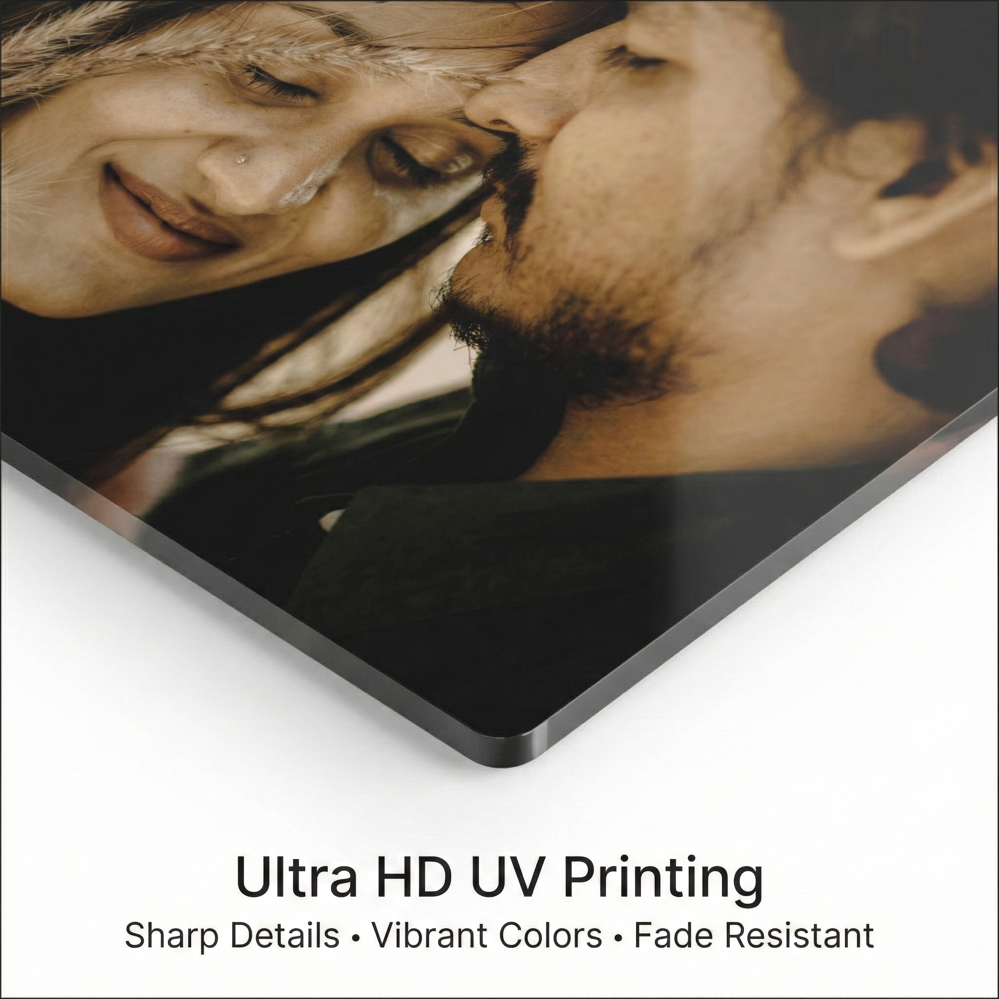 Corner close-up of clear acrylic photo print with high-contrast portrait detail