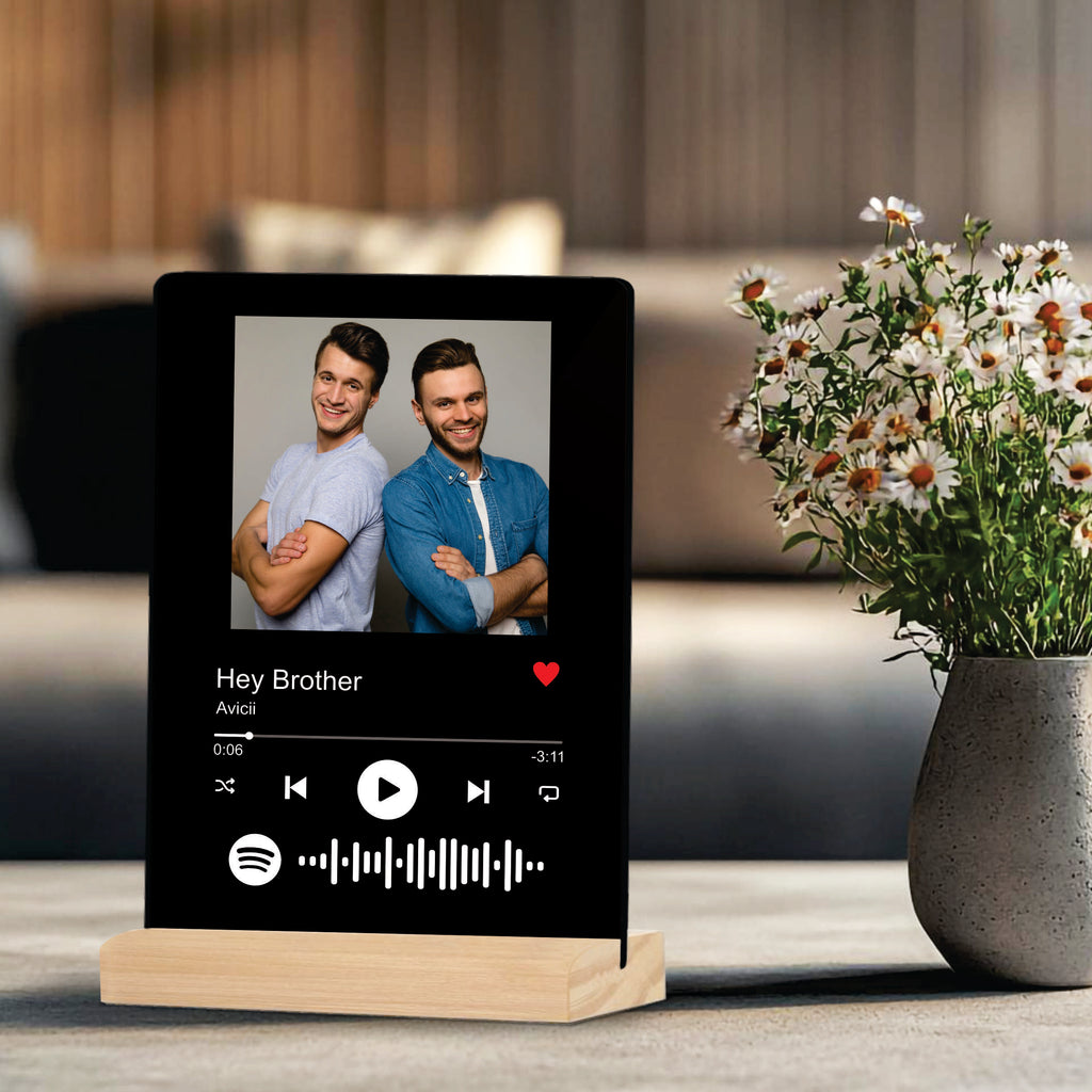 Black acrylic photo frame on wooden stand with two men portrait and music controls