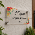 Transparent acrylic door sign with floral corners; names and A-87.