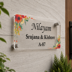 Transparent acrylic door sign with floral corners; names and A-87.