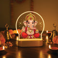 LED night light with illuminated arch, red-robed Ganesha figure on a wooden base