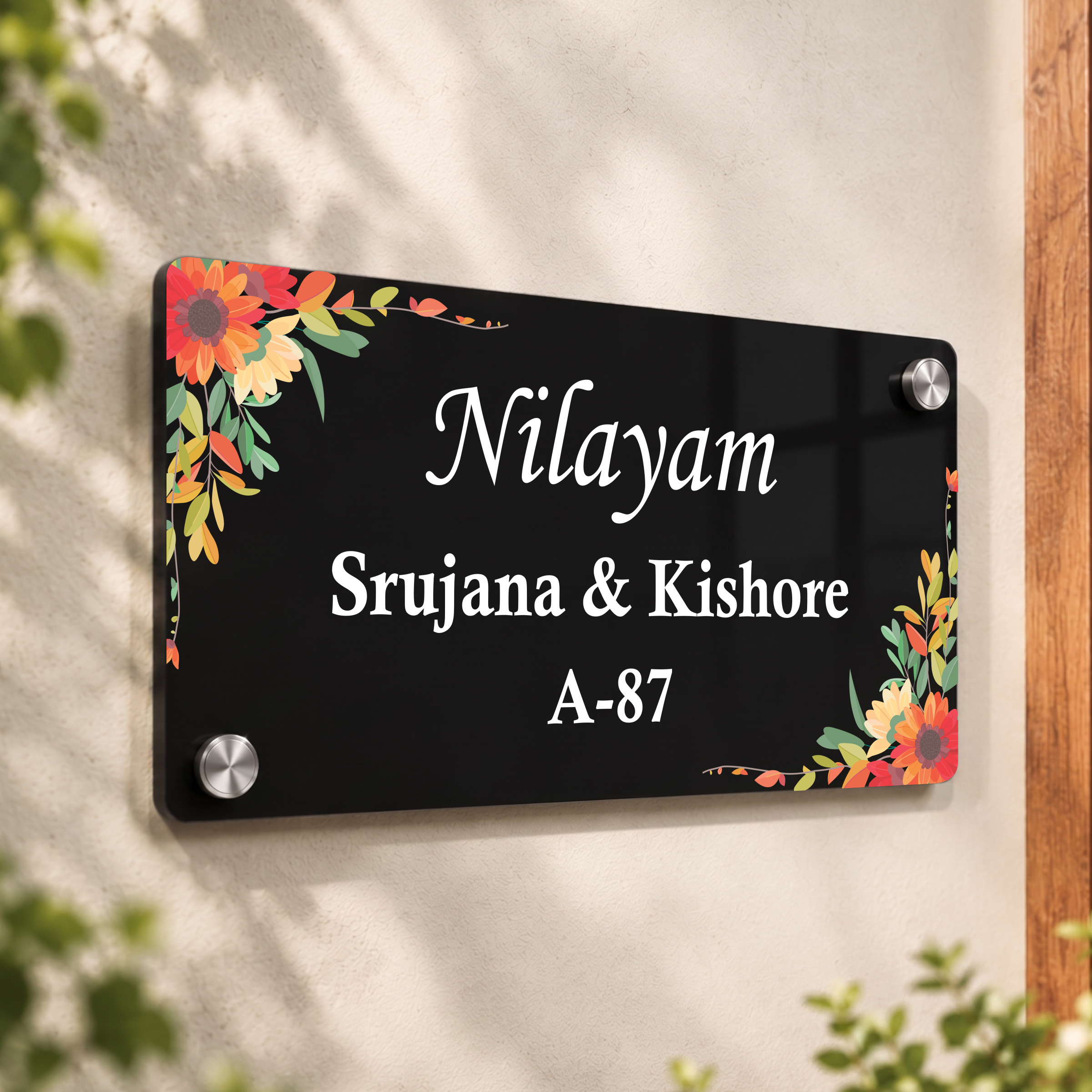 Black acrylic door name plate with floral border, Nilayam Srujana & Kishore A-87, screws