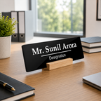 Black acrylic name plate with Mr. Sunil Arora and Designation, resting on wooden stand