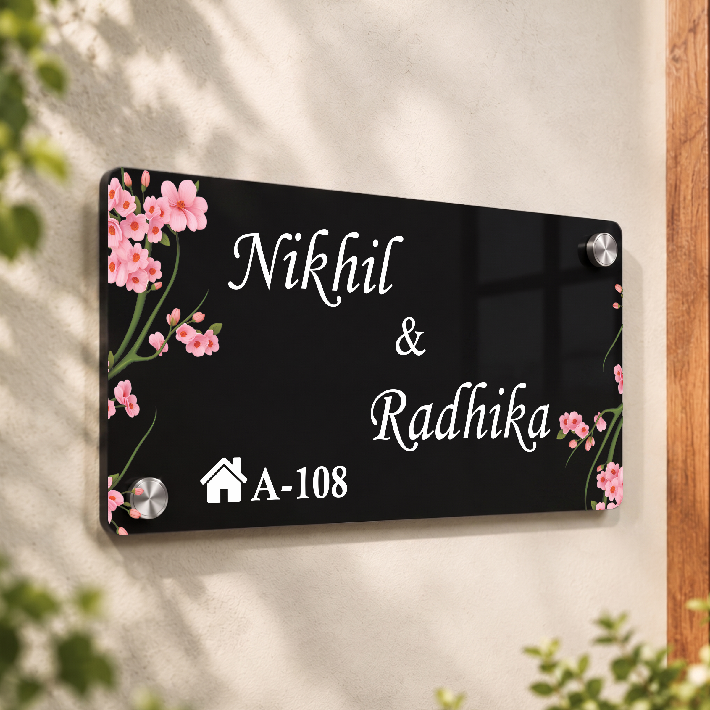 Black acrylic door name plate with cherry blossoms, Nikhil & Radhika, A-108; corner bolts