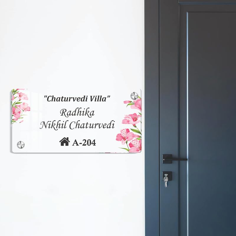 Transparent acrylic door name plate with pink floral corners and “Chaturvedi Villa” “A-204”