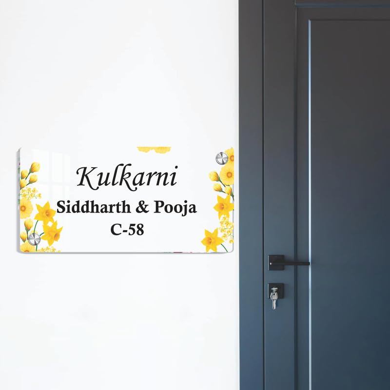 Transparent acrylic door name plate with yellow floral accents and metal mounting corners