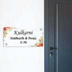 Transparent acrylic door sign with floral border; names and C-58, with screws.
