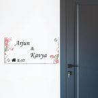 Transparent acrylic door name plate with cherry blossom design: Arjun & Kavya, E-17.