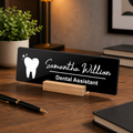 Black acrylic desk name plate, white tooth icon and name script, “Dental Assistant”, wood stand