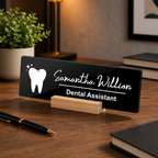 Black acrylic desk name plate, white tooth icon and name script, “Dental Assistant”, wood stand