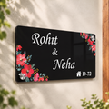 Black acrylic door name plate with floral corners and engraved text, Rohit & Neha