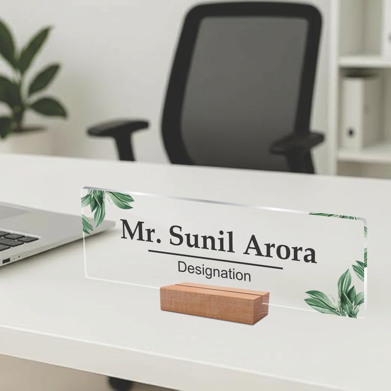 Clear acrylic name plate with green leaf print, engraved name and designation on wood stand
