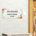 Transparent acrylic door sign with floral border; Deshmukh names and B-105.