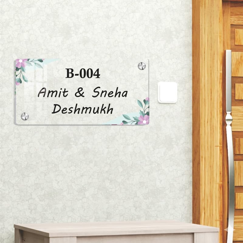 Transparent acrylic door name plate with pastel floral corners, text B-004 Amit & Sneha Deshmukh