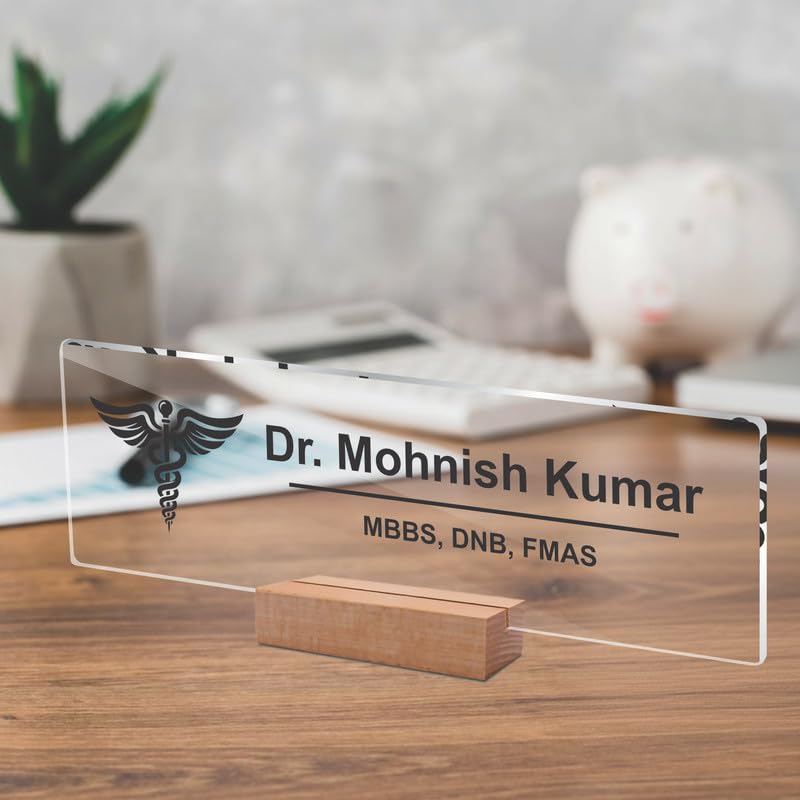 Transparent acrylic desk name plate with Dr. Mohnish Kumar and medical credentials, on wood stand