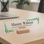 Transparent acrylic desk name plate: Manny Wilson, manager, green leaf border