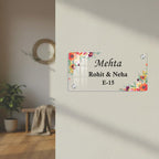 Transparent acrylic door sign with floral border; Mehta names and E-15.