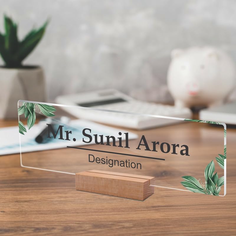 Clear acrylic name plate with green leaf corners, engraved name and designation on wood stand