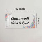 Transparent acrylic name plate, 12 inch, with floral corners and “Chaturvedi Neha & Rohit”