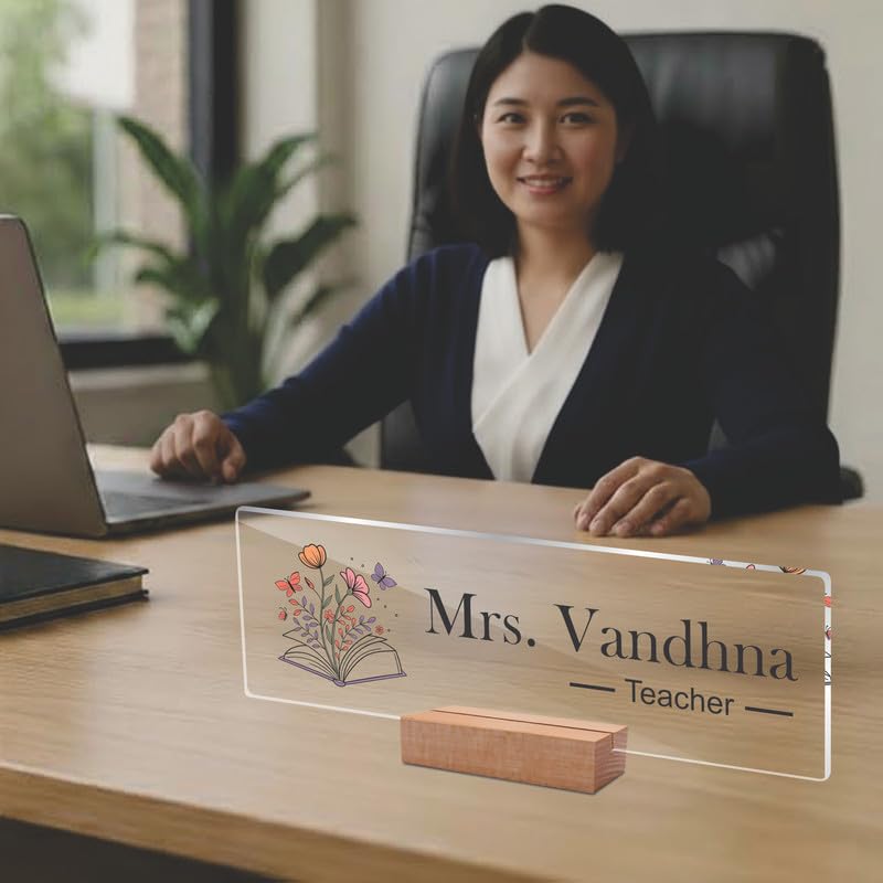 Transparent acrylic name plate on a wooden stand with Mrs. Vandhna and Teacher text.