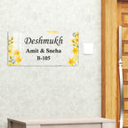 Transparent acrylic door name plate with yellow flower design and metal corner screws