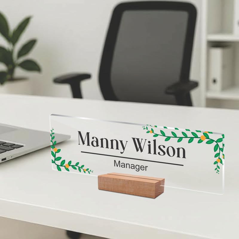 Transparent acrylic desk name plate: Manny Wilson, manager, leaf border; wooden stand