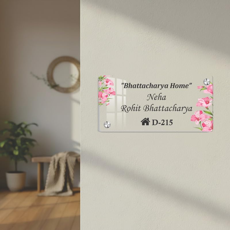 Transparent acrylic door name plate with pink floral corners and “Bhattacharya Home” “D-215”