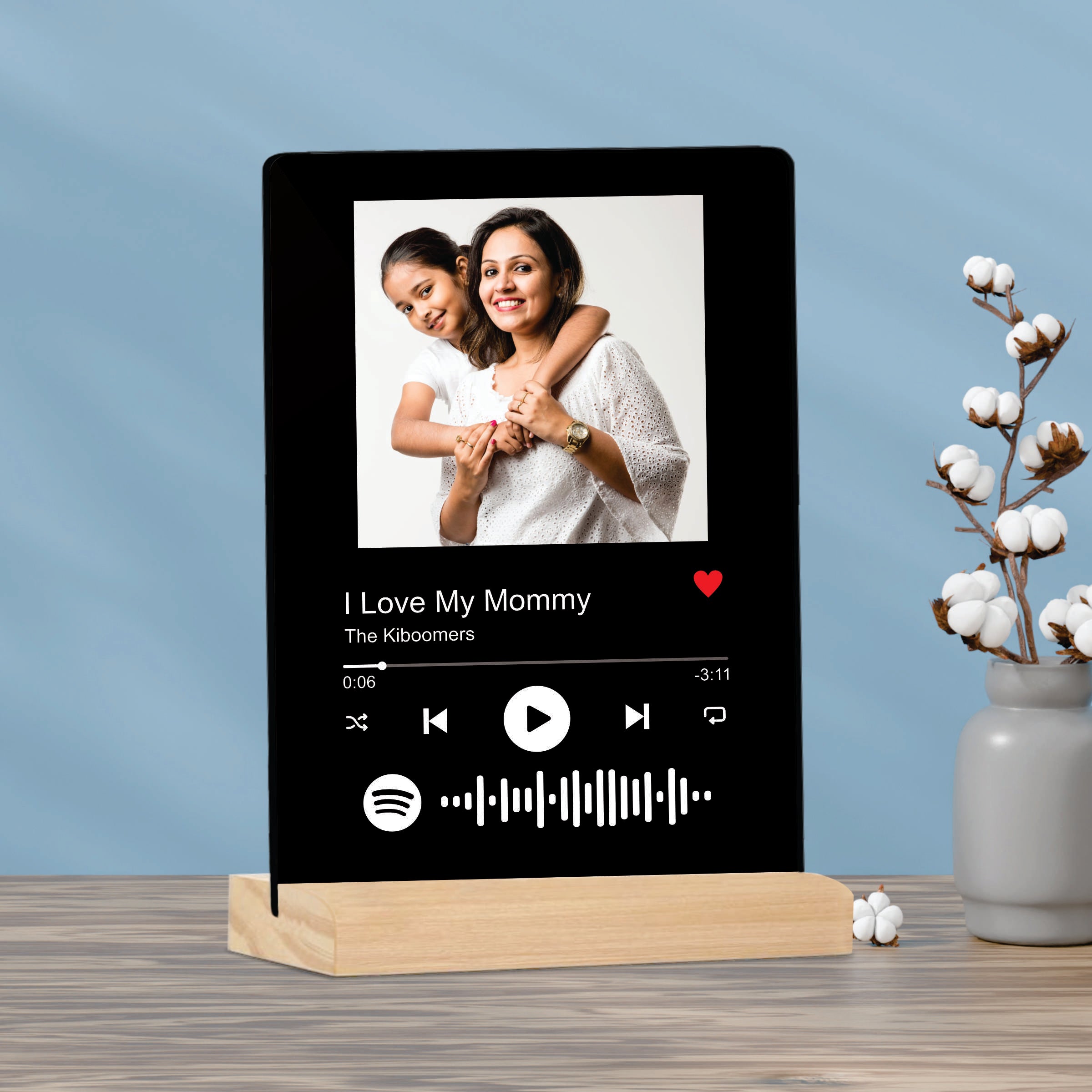 Black acrylic photo frame on wooden stand with mother photo and playback icons
