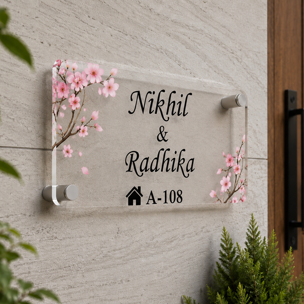 Transparent acrylic door name plate with cherry blossom design: Nikhil & Radhika, A-108.