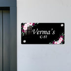 Black door name plate with pink floral corners and name "Verma" C-57