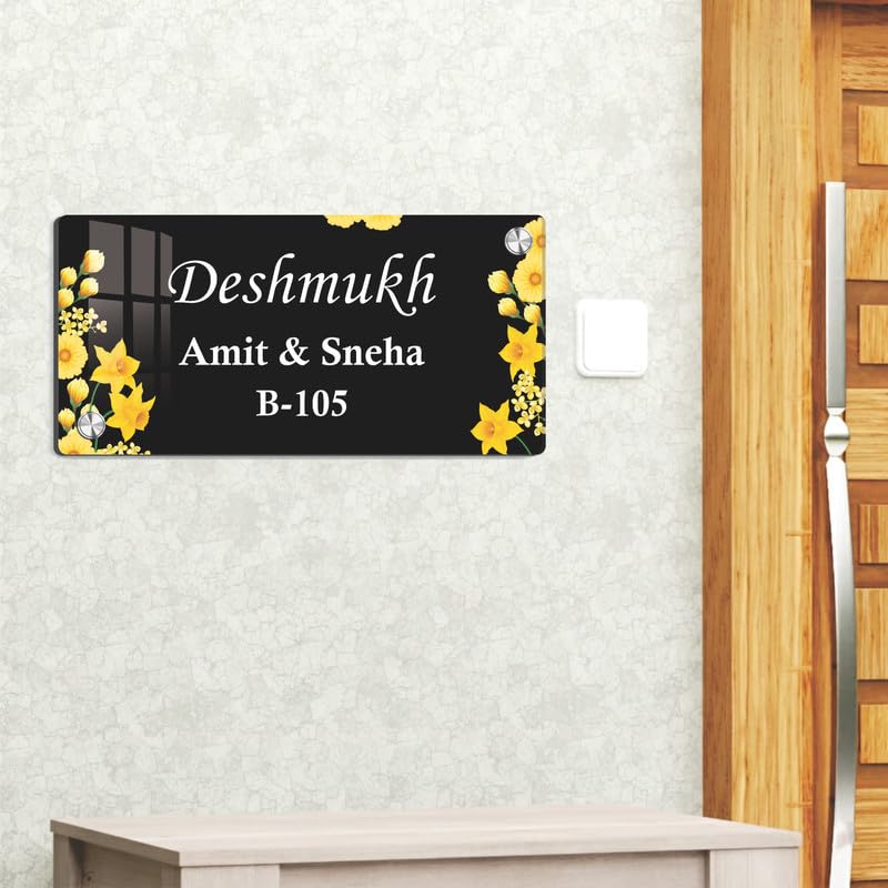 Black acrylic door name plate with yellow flower border on textured wall