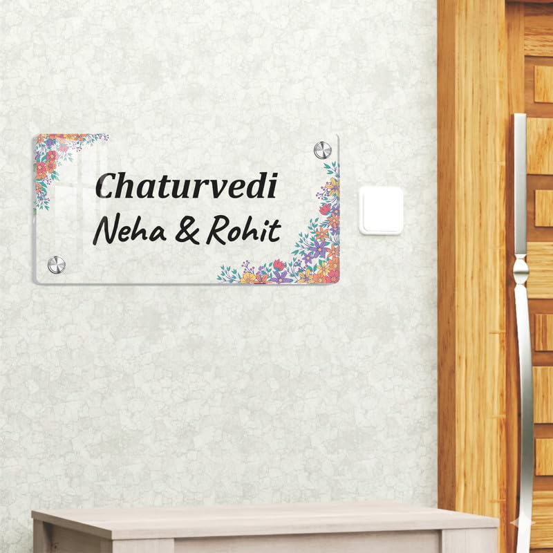 Transparent acrylic name plate with floral corners and engraved “Chaturvedi Neha & Rohit”