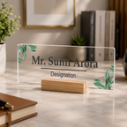 Clear acrylic name plate with green leaf print, engraved name and designation