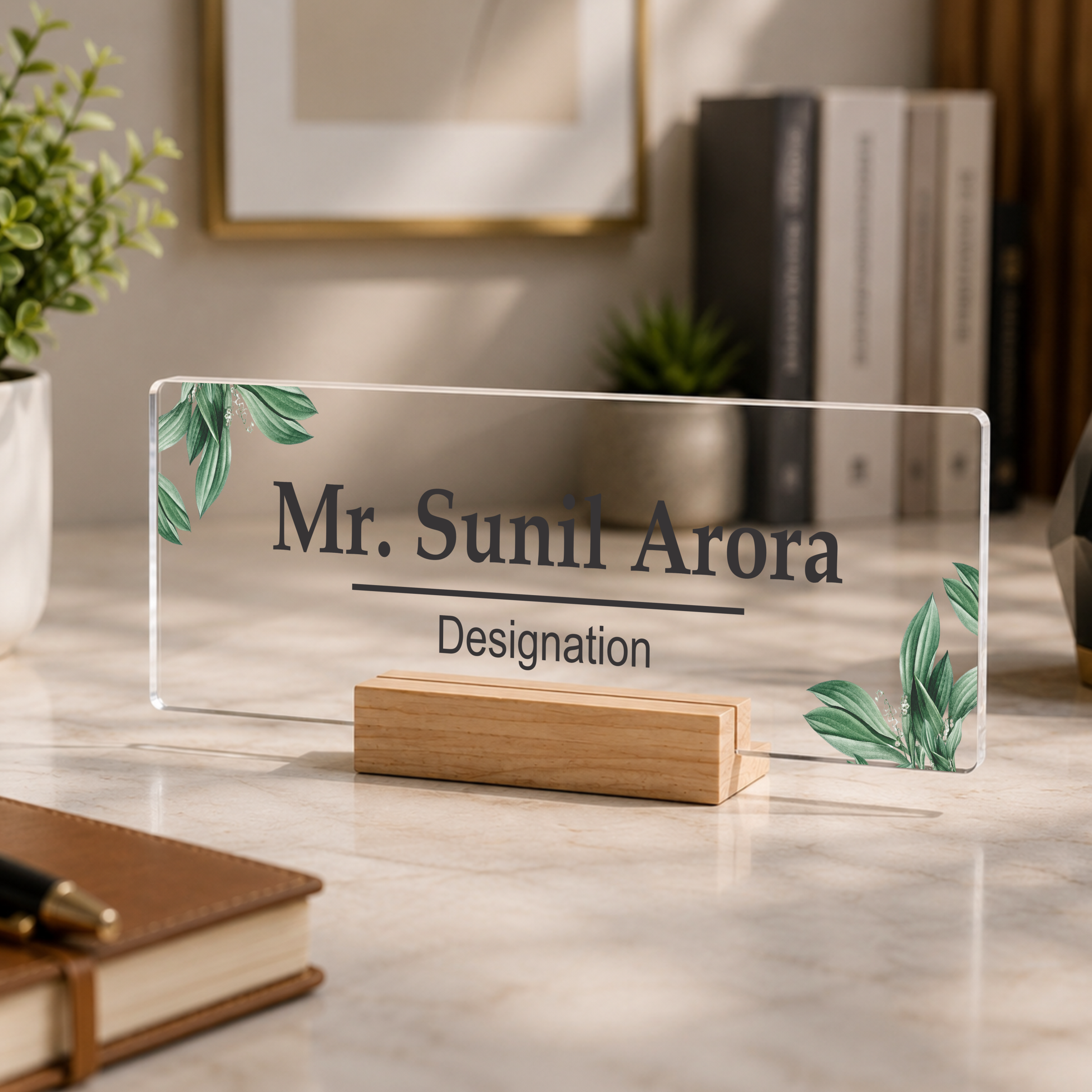 Clear acrylic name plate with green leaf print, engraved name and designation
