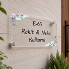 Transparent acrylic door name plate with pastel floral corners, text E-63 Rohit & Neha Kulkarni