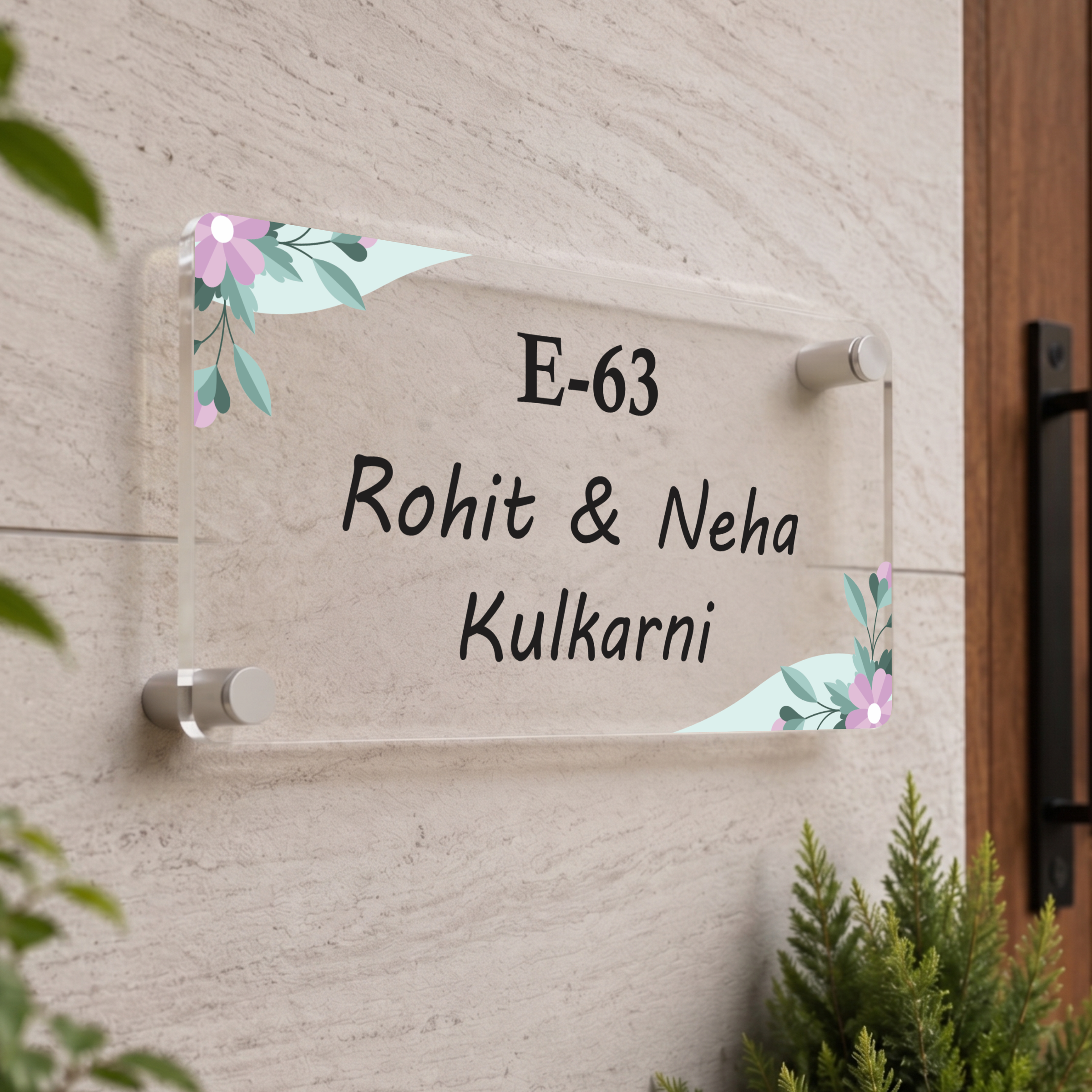 Transparent acrylic door name plate with pastel floral corners, text E-63 Rohit & Neha Kulkarni