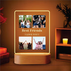 LED acrylic photo frame with four photos and warm glowing border, on wood base