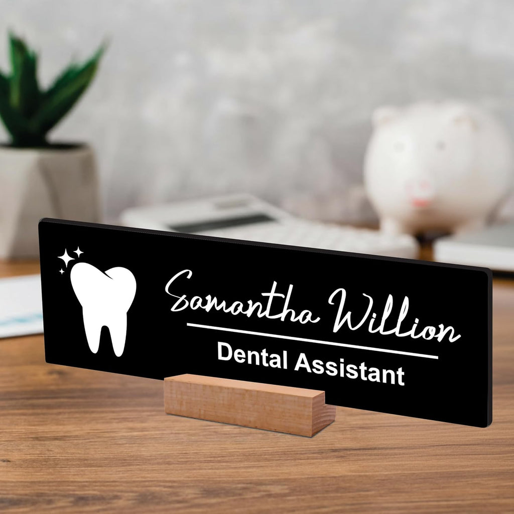 Black acrylic desk name plate with white tooth icon and name script, “Dental Assistant”, wood stand