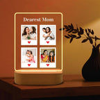 Edge-lit LED acrylic photo frame with four portrait tiles, warm glow, and wood base