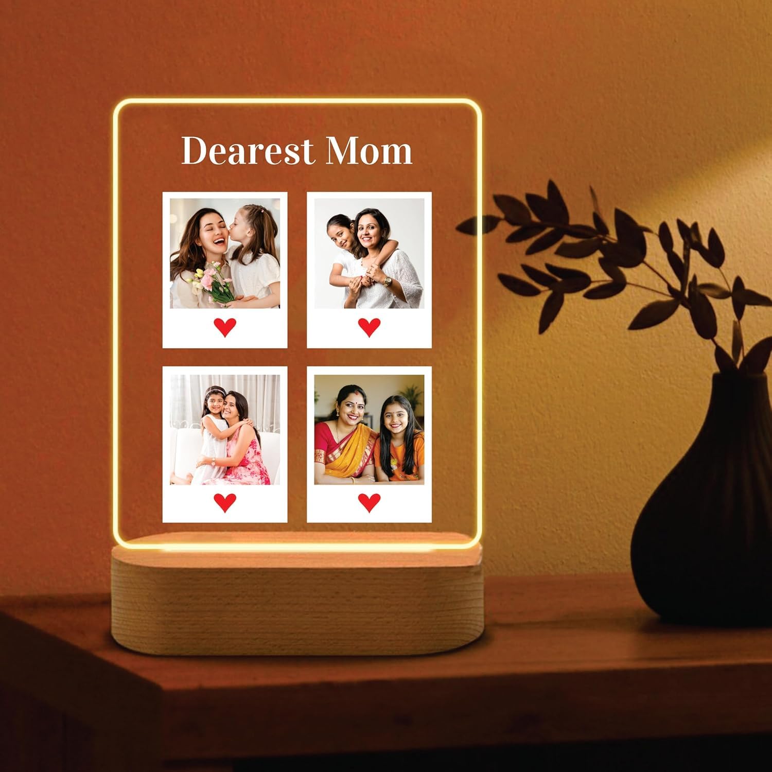 Edge-lit LED acrylic photo frame with four portrait tiles, warm glow, and wood base