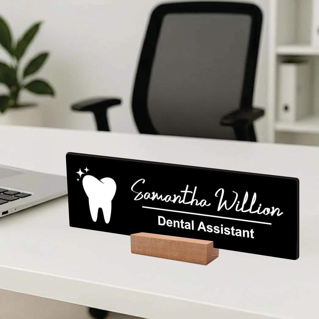 Black acrylic desk name plate with white tooth icon, name script, “Dental Assistant”, wood stand