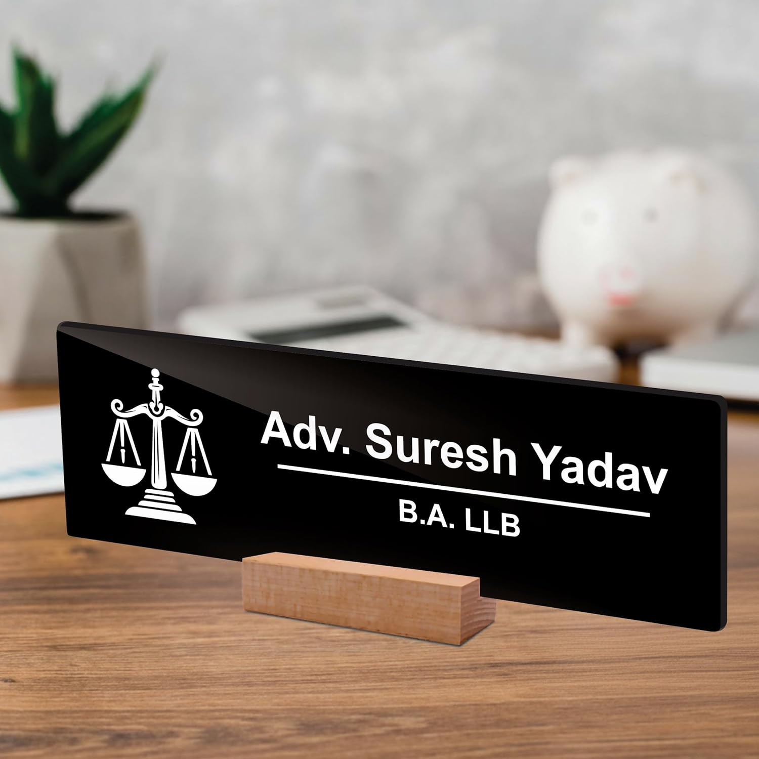 Black acrylic desk plate on wood stand with scales icon: Adv. Suresh Yadav, B.A. LLB