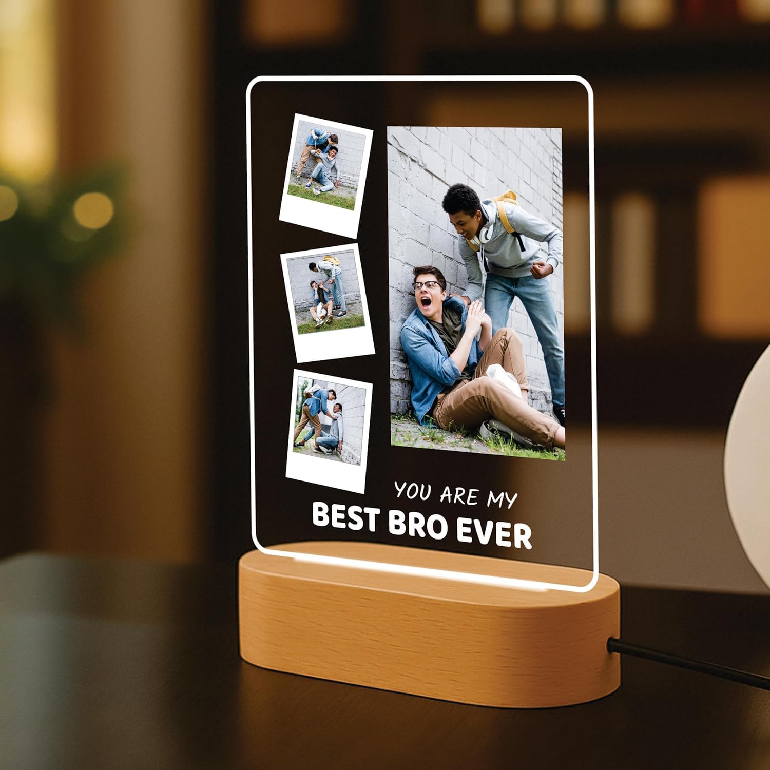 LED acrylic photo frame with three photos and one large portrait, on wood base.