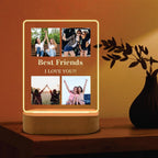LED acrylic photo frame with four photos and warm glowing border, wood base