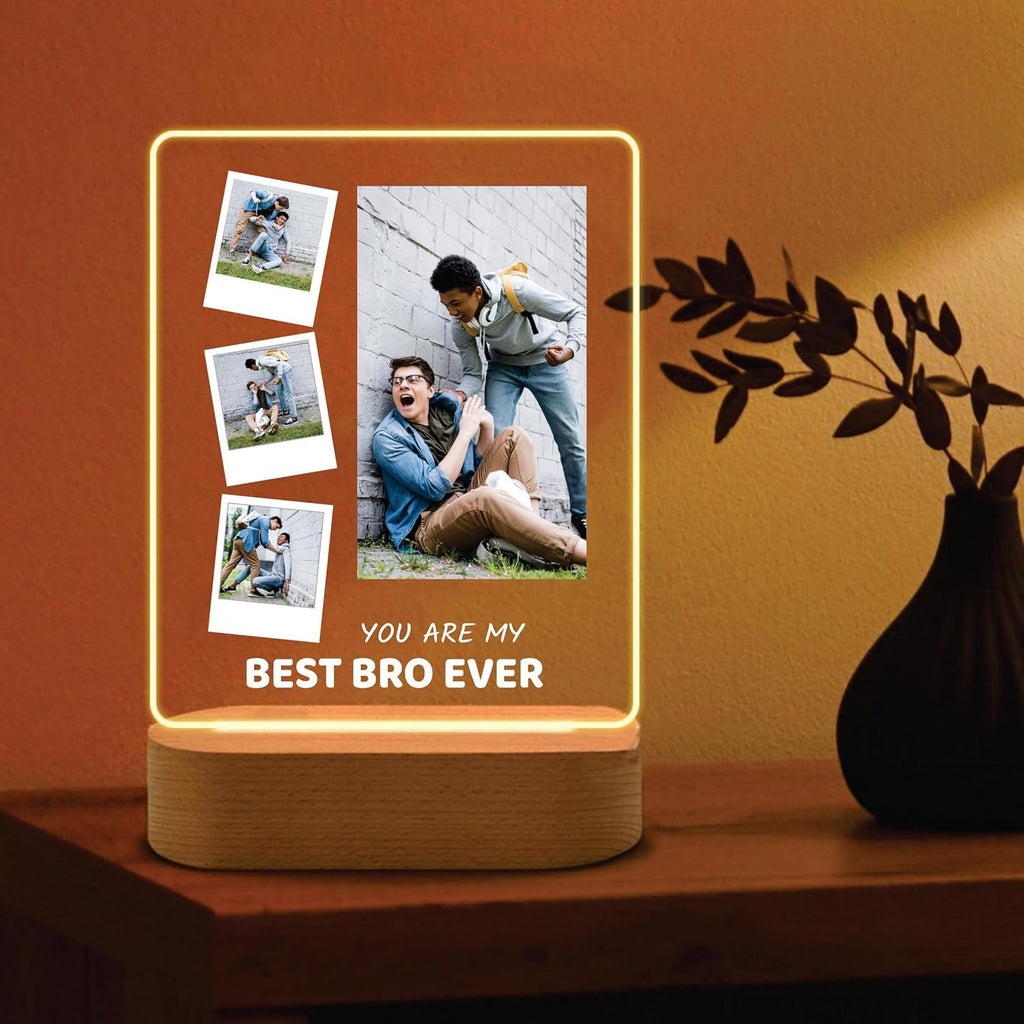 LED acrylic photo frame with glowing outline, three photos and one large photo, wood base.