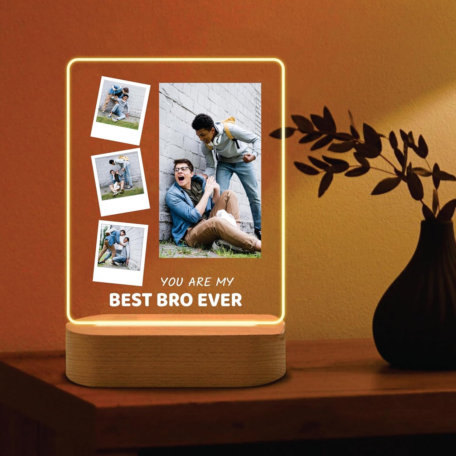 LED acrylic photo frame with glowing outline, three photos and one large photo, wood base.